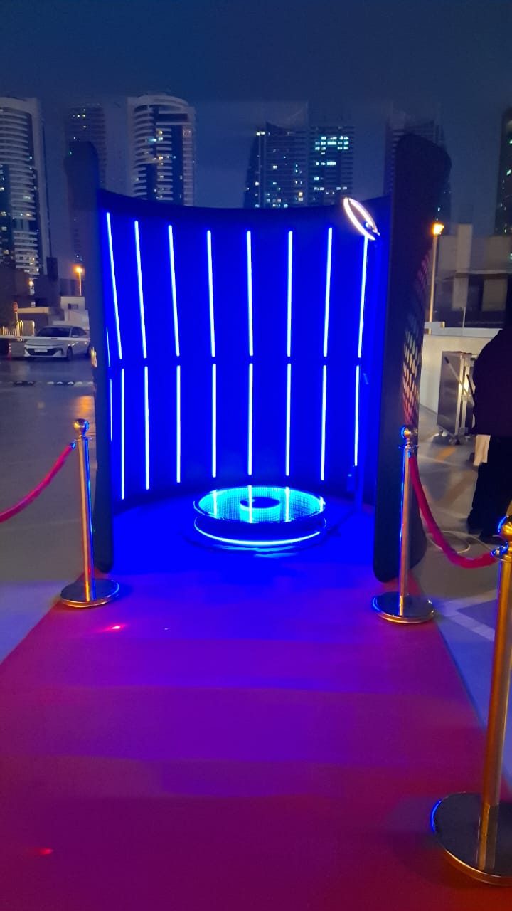 LED Backdrop setup with blue lights and red carpet, perfect for events and rentals.